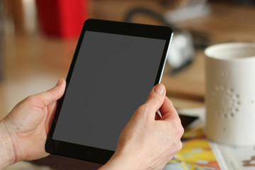 handheld tablet device in portrait orientation in a living room environment