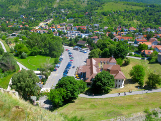 Fototapeta na wymiar Slovakia, Devin town. Top view from Devin castle. Eco-friendly urban landscape. Houses, parking for cars, forest and meadows.
