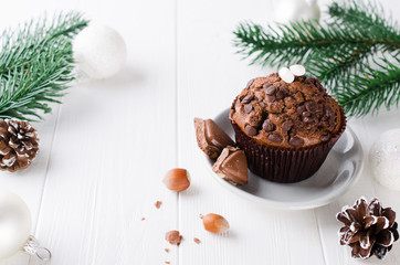 Chocolate muffin on white wooden background.
