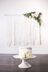 Beautiful Cake with floral boho weaving decor on wall
