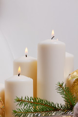 Obraz na płótnie Canvas White burning advent candles with christmas decorations