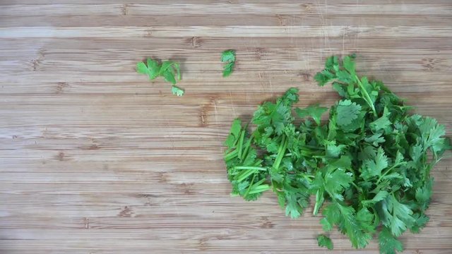 Chopping parsley on a cutting board, time-lapse
