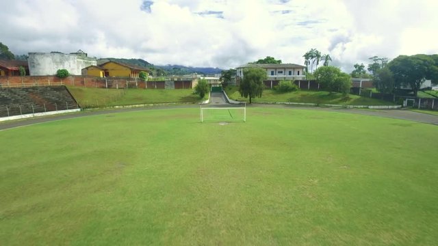 Great Aerial shot of a soccer/futbol stadium and homes in Colombia 