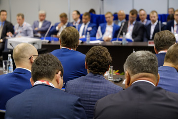 Audience listens to the lecturer at the conference hall