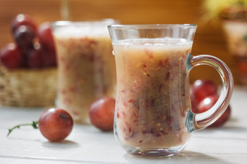 Grape smoothie over the white table.