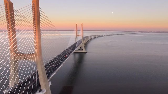 Vasco da Gama bridge over the Tagus river at sunset in Lisbon, Portugal, aerial view.