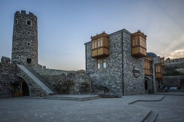 Georgia, Akhaltsikhe. Medieval, recently restored fortress Rabat, against the backdrop of the rays of the setting sun.