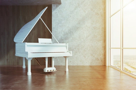 White piano in a concrete and wooden room toned