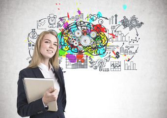 Smiling businesswoman with notebook, cog brain