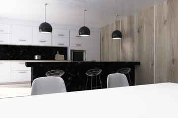White kitchen with a black bar stand, table