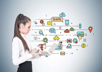 Serious young businesswoman, laptop, social media