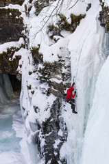 Man climbing waterfall