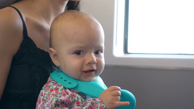 A Baby Girl Playing And Eating An Orange Puree On The Train. Close-up Shot.