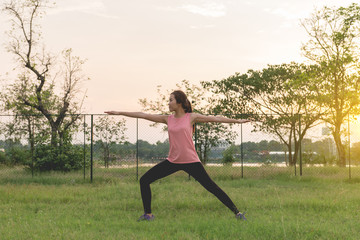 Asian woman play yoga on sunset,Exercise makes the body strong.