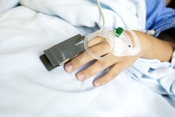 SpO2 Sensor (peripheral capillary oxygen saturation) and Iv Drip on Patient Hands at the Hospital...