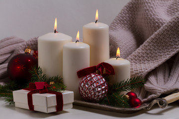 White burning advent candles with christmas decorations