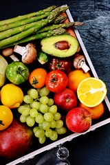 Fresh fruit and vegetables on the dark background. Shopping bag