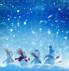Merry Christmas and happy New Year greeting card with copy-space.Many snowmen standing in winter Christmas landscape.Winter background