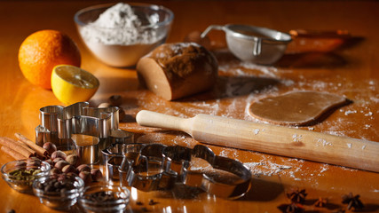Cooking and decorating christmas gingerbread men. Homemade gingerbread cookies, metal forms and baking ingredients.