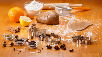 Cooking and decorating christmas gingerbread men. Homemade gingerbread cookies, metal forms and baking ingredients.