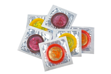Multicolored condoms isolated on white background