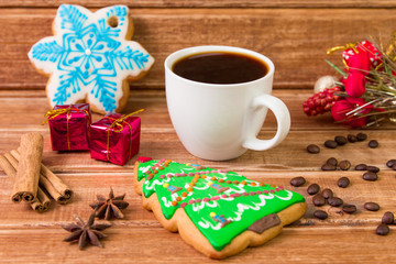 White Cup with coffee and christmas cookies. Christmas Food decor on wooden background