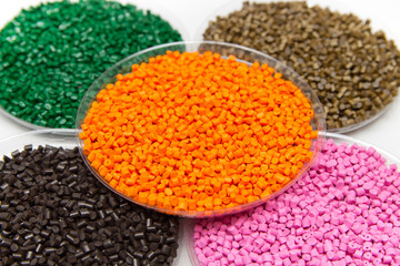The plastic granules. Dye for polypropylene, polystyrene granules into a measuring container