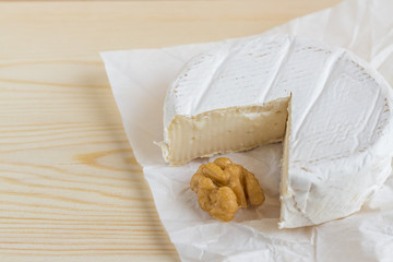 camembert and walnut on wooden background