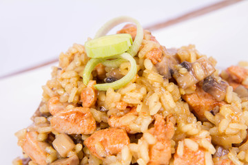 Risotto with mushrooms and chicken decorated with leek