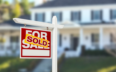 Sold Home For Sale Real Estate Sign in Front of Beautiful New House.