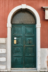 Fototapeta na wymiar Old wooden door in a stone house Italian