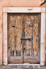 Old wooden door in a stone house Italian