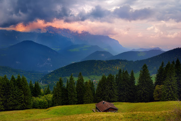 Breathtaking lansdcape of Bavarian mountains and forests on cloudy sunset. Scenic view of Bavarian Alps with majestic mountains in the background.