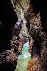 Blue water flowing in the Partnach Gorge or Partnachklamm, incised by a mountain stream in the Reintal valley near the town of Garmisch-Partenkirchen.