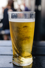Pint of cider on an outside table at a pub.