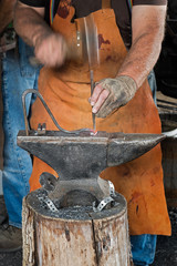 Blacksmith Punches Horseshoe