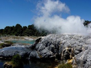 landscape of hot geotermal area with colored water and mud, New Zealand