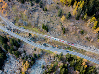 Aerial view orailway track and road in mountain valley in Switzerland