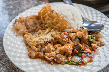 Thai Food - Thai Hot Crispy Pork Basil Rice With Fried Egg on White Dish and Granite Dining Table at Lunch