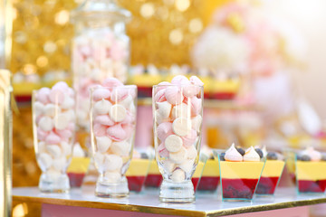 Wedding candy bar table withdesserts and other sweetsTwo