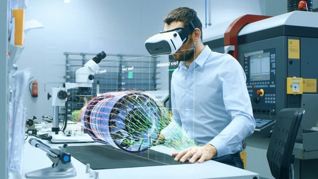 Factory Chief Engineer Wearing VR Headset Designs Engine Turbine on the Holographic Projection Table.  Futuristic Design of Virtual Mixed Reality Application.