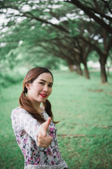 Portrait of beautiful asian woman under tunnel trees,happy woman in the forest vintage style,retro