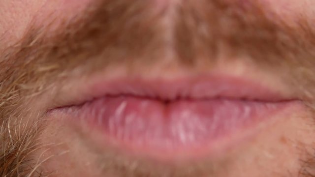 Close-up of teeth. A man shows his denture on two teeth. There are not enough two teeth, instead of them a plastic prosthesis