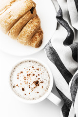 Cappuccino on a striped tablecloth. Morning coffee.