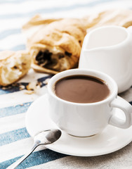 Cappuccino on a striped tablecloth. Morning coffee.