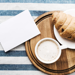 Cappuccino on a striped tablecloth. Morning coffee.