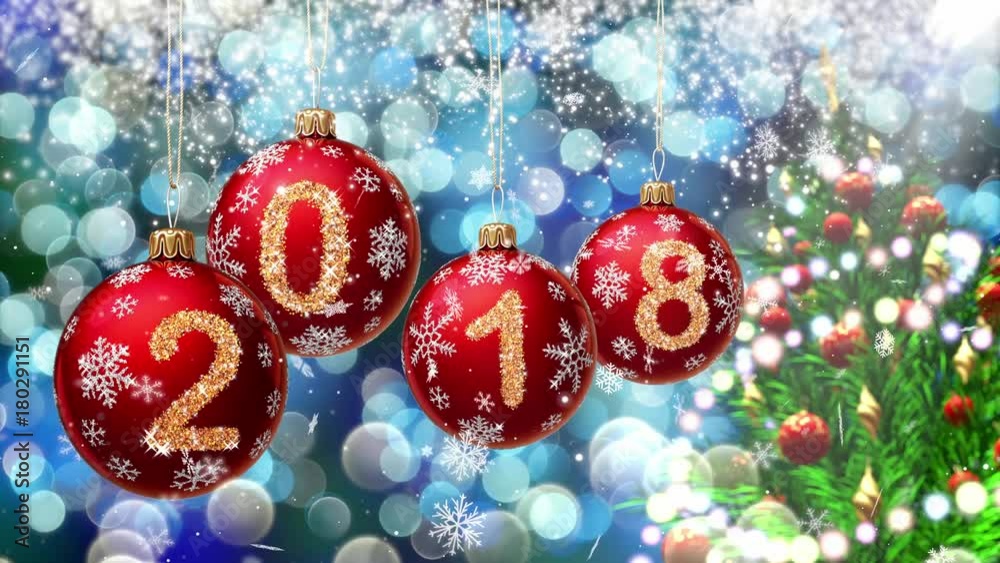 Wall mural red balls with numbers 2018 hanging on the background of a blue bokeh and a rotating christmas tree 