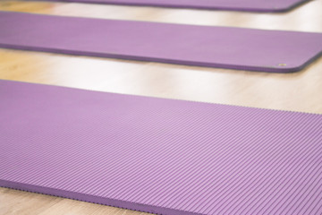 Yoga mat on wooden floor