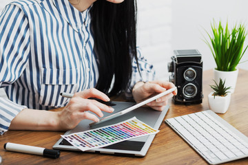Modern designer sitting in front of computer in office