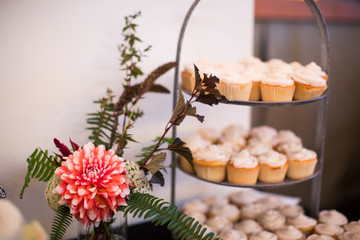 vanilla cupcakes at wedding with florals